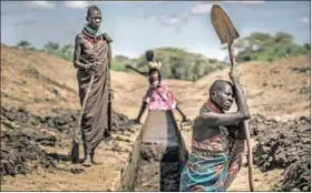  ?? Photo: Luis TATO/AFP ?? Drought: People unblock an irrigation canal in Lodwar, Kenya. Adapting to climate change will be on the agenda in Gabon.