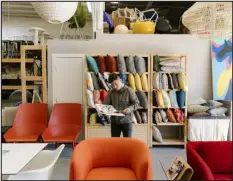  ?? JASON HENRY — THE NEW YORK TIMES ?? Tenzin Norbu, who runs a furniture reselling company called Enliven, at his showroom in Richmond, Calif., on Feb. 15. As tech companies cut costs and move to remote work, their left behind office furniture has become part of a booming trade.