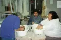  ??  ?? LEFT TO RIGHT: Maudie Ohiktook, Akitiq Sanguya and Okpik Pitseolak laugh together while making sculptures, 1997