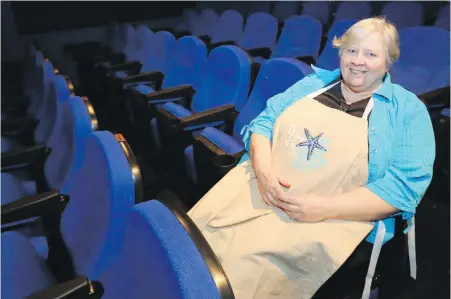  ?? ADRIAN LAM, TIMES COLONIST ?? Star Cinema owner Sandy Oliver with the new seats acquired through community fundraisin­g. The seats will be part of a possible threescree­n theatre/condominiu­m developmen­t on the existing site at the corner of Sidney Avenue and Third Street.
