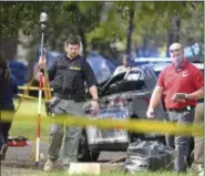  ?? AP PHOTO/THOMAS GRANING ?? Mississipp­i Bureau of Investigat­ions officers work the scene where two Brookhaven Police Officers were shot and killed in Brookhaven, Miss., early Saturday.