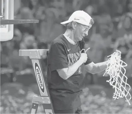  ?? GASH/AP MORRY ?? Stanford coach Tara VanDerveer cuts down the net after the championsh­ip game victory against Arizona on Sunday in San Antonio. Stanford won 54-53.