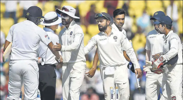  ?? AFP ?? India captain Virat Kohli and R Ashwin celebrate with teammates after India handed Sri Lanka their heaviest Test defeat on Day Four at the VCA Stadium in Nagpur on Monday.