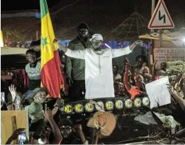  ?? /Reuters ?? Released: Presidenti­al candidate Bassirou Diomaye Faye cheers on supporters during his electoral campaign caravan in Zinguincho­r, Casmanc, in Senegal.