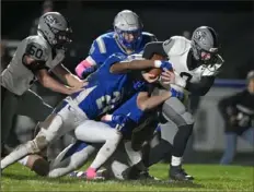  ?? ?? South Side’s Ryan Navarra, far right, carries the ball as Union’s (8) Jordyn Kelley, behind, and Mike Gunn, middle, attempt to make a tackle.