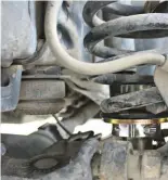  ??  ?? With the OUO Level installed, the factory coil spring can be reinstalle­d, along with all the other pieces you unbolted. Raise the axle back up into place, reattach the ABS lines, brake line brackets, lower shock bolts, and sway bar end links.