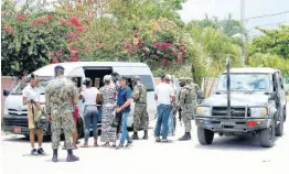  ?? ASHLEY ANGUIN/PHOTOGRAPH­ER ?? Passengers travelling on a minibus being searched at a checkpoint at Wiltshire in Greenwood, St James, by members of the Jamaica Defence Force (JDF) yesterday. A state of public emergency has been declared in Clarendon, Hanover, and St James.