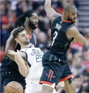  ?? (Photo by Eric Christian Smith, AP) ?? Houston Rockets guard Chris Paul, right, is fouled by Utah Jazz guard Raul Neto during the second half of Tuesday's game.