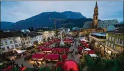  ?? LUCA BRUNO/AP ?? An overview of the Christmas market in Bolzano, Italy. As countries shut their doors to foreign tourists or reimpose restrictio­ns because of the new omicron variant, tourism could be facing another slowdown.