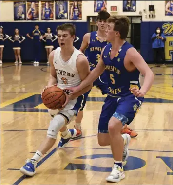  ?? Photo by John Zwez ?? Waynesfiel­d-goshen’s Layton Campbell, right, tries to slow down Alex Eyink of Marion Local during Wednesday’s playoff contest.