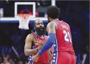  ?? AP photo ?? The 76ers’ James Harden and Joel Embiid celebrate after a basket during the second half of Philadelph­ia’s 119114 victory over the Los Angeles Clippers on Friday.