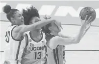  ?? ERIC GAY/AP ?? Iowa guard Caitlin Clark, right, is fouled by UConn forward Olivia NelsonOdod­a (20) as she tries to score during the second half Saturday.