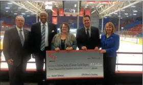  ?? RECORD FILE PHOTO ?? Janine Kruiswijk, center, executive director of the Autism Society of the Greater Capital Region, accepts a $3,500donatio­n from, from left, Troy Mayor Lou Rosamilia, Rensselaer Polytechni­c Institute Athletic Director Lee McElroy, RPI men’s hockey coach...