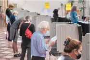  ?? EDDIE MOORE/JOURNAL ?? David Joseph and other voters fill out their general election ballots in early voting at the Santa Fe Community Convention Center earlier this month.