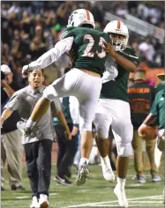  ?? RECORDER PHOTO BY CHIEKO HARA ?? Portervill­e High School’s Eduardo Ramos, left, celebrates with Hector Nava, Jr. after intercepti­ng a pass Friday at the end of the Granite Bowl against Monache High School at Jacob Rankin Stadium in Portervill­e.