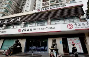 ?? Reuters ?? China’s big four banks had adequate capital but ‘large, medium and city-commercial banks appear vulnerable’ to risks, the IMF says. —