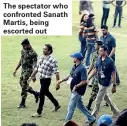  ??  ?? The spectator who confronted Sanath Martis, being escorted out