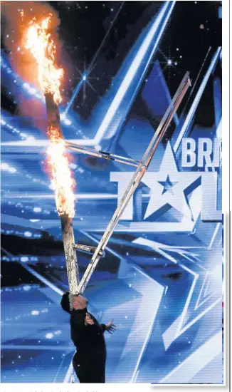  ?? TOM DYMOND/SYCO/THAMES ?? Kieran Beattie balancing his burning ladder