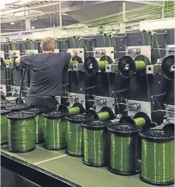  ?? Picture: Don & Low. ?? A technician works on the new synthetic grass yarn line at the firm’s Forfar base.