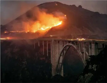  ?? KARL MONDON — BAY AREA NEWS GROUP ?? The Colorado fire burns down toward the famed Bixby Bridge in Big Sur early Saturday morning.