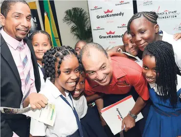  ?? RUDOLPH BROWN/PHOTOGRAPH­ER ?? Senator Don Wehby (centre), group CEO of GraceKenne­dy Limited, and Senator Delroy Williams, mayor of Kingston, posing with Manley Music Room students at the launch of the ninth staging of the GraceKenne­dy Education 5K Run/Walk at GraceKenne­dy, Harbour...