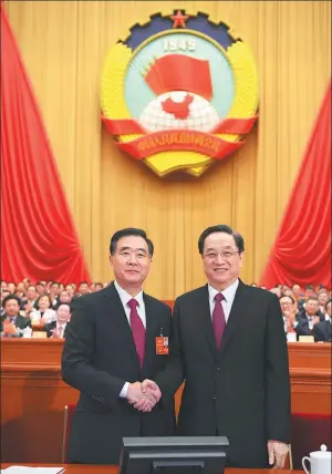  ?? LI XUEREN / XINHUA ?? Wang Yang (left), elected chairman of the 13th National Committee of the Chinese People’s Political Consultati­ve Conference, shakes hands with Yu Zhengsheng, chairman of the 12th CPPCC National Committee, on Wednesday.