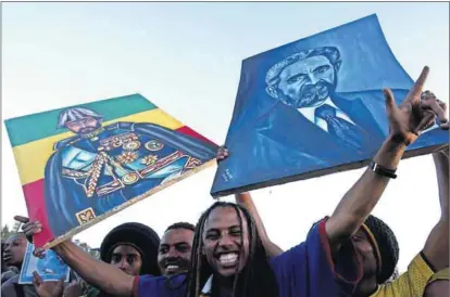  ??  ?? On a high: A Rastafaria­n waves a portrait of the late Emperor Haile Selassie at a concert in Addis Ababa in 2005, marking the 60th anniversar­y of Bob Marley’s birthday. Photo: Antony Njuguna/Reuters