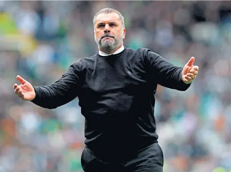  ?? ?? CHOIR BHOYS: Ange Postecoglo­u conducts the Celtic faithful after their victory over Hearts all but secured the title.