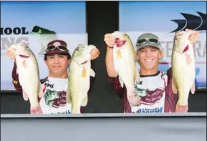  ?? Submitted photo ?? IT’S CATCHING: Hunter Davis, left, and Tyler Allenbrand display some of the fish they caught in the final round of a national high school fishing tournament last week on Alabama’s Pickwick Lake. As champions of the three-day event, the two Mount Ida...