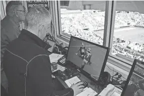  ?? STEVE COLQUITT/GEORGIA ATHLETICS ?? USA TODAY writer George Schroeder looks at a replay during the Georgia spring football game Saturday.