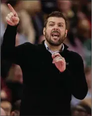  ?? (AP/Michael Conroy) ?? Coach Austin Parkinson and IUPUI earned the school’s first bid to the NCAA Women’s tournament this season when it won the Horizon League Conference championsh­ip. After the NCAA canceled the tournament for health and safety reasons, IUPUI never got its chance to play in the tournament.