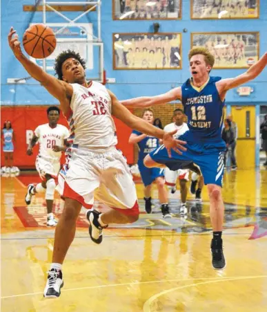 ?? STAFF PHOTO BY ANGELA LEWIS FOSTER ?? Brainerd’s Jessie Walker snags a pass as Livingston Academy’s Xander Miller guards him during the Panthers’ 74-55 Class AA sectional win Monday night. Walker scored a game-high 28 points, 16 occurred in the first half.