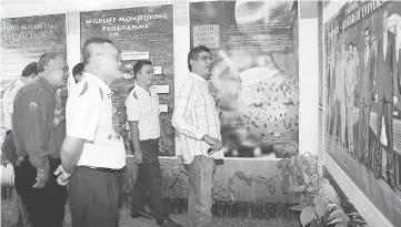  ??  ?? (From left) Shahril, Law and Sam (at right) visit an exhibition booth.