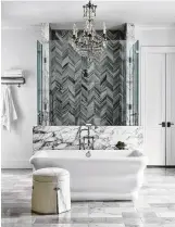 ??  ?? Carrara marble laid in a herringbon­e pattern adds personalit­y to the shower.