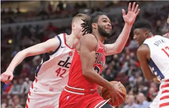  ?? GETTY IMAGES ?? The Bulls’ Coby White drives past the Wizards’ Davis Bertans on Sunday at the United Center.