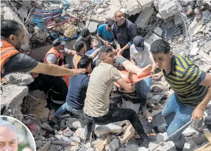  ?? Photos / AP ?? Palestinia­ns rescue a survivor from under the rubble of a destroyed residentia­l building following Israeli airstrikes in Gaza City. Israeli Prime Minister Benjamin Netanyahu yesterday said Israel “wants to levy a heavy price” on the Hamas militant group.