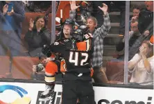  ?? Jae C. Hong / Associated Press ?? Ondrej Kase celebrates with Josh Manson (42) after scoring in overtime to give Anaheim a victory over Colorado.