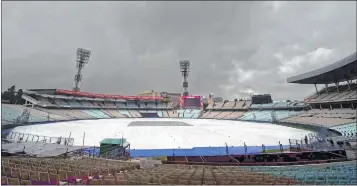  ??  ?? The Eden Garden field is covered due to rains in Kolkata on Tuesday. The filed of the iconic stadium is covered since last few days