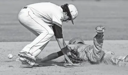  ?? Photos by Tom Reel / San Antonio Express-News ?? Rattlers shortstop DaltonBrie­ger gets the ball knocked loose by Carroll's Adam Stephenson during a rundown in Saturday’s game.