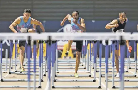  ??  ?? From left, Devon Allen, Aries Merritt, and Aleec Harris run the men’s 110-meter hurdles at the U.S. Track and Field Championsh­ips on Sunday in Sacramento, Calif. Harris won the event, Merritt finished second and Allen finished third.