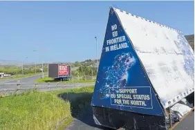  ??  ?? A billboard outside Carrickcar­nan calls for “no EU frontier in Ireland” and for Northern Ireland to have special status.