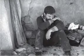  ??  ?? Ahmed Pesher on Friday cries next to the destroyed houses where he says 23 members of his family were killed during fights between Iraqi security forces and the Islamic State on the western side of Mosul, Iraq. Felipe Dana, The Associated Press