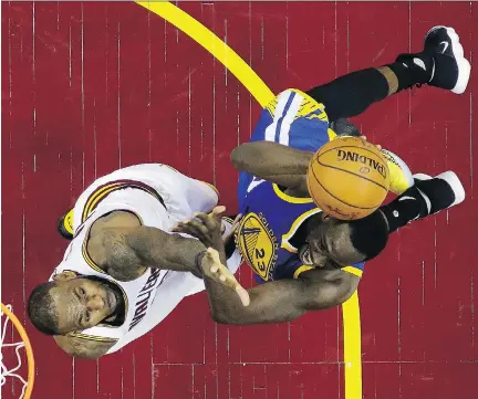  ?? RON SCHWANE/GETTY IMAGES ?? Draymond Green, right, tries to outmuscle LeBron James to the basket during Game 4 of the NBA Finals.