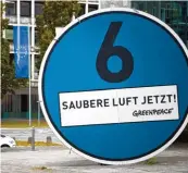  ?? Fotos: Bockwoldt; Murat, dpa ?? Montage für Fahrverbot­sschilder für Diesel Lkw in Hamburg, Greenpeace Protest für Umwelt Plakette in Stuttgart: „Die Blaue Plakette ist der Einstieg in Fahrverbot­e“, lehnt CSU Minister Scheuer die Verschärfu­ngen ab.