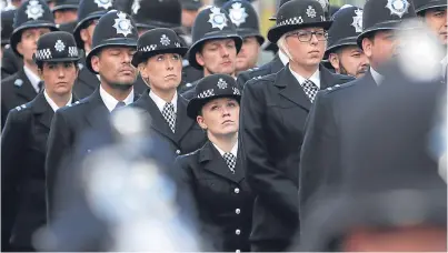  ??  ?? Police officers gathered near Southwark Cathedral before the funeral service.