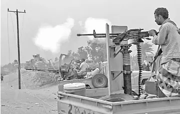  ?? — AFP photo ?? In this file image grab taken from a AFPTV video,Yemeni pro-government forces fire a heavy machine gun at the south of Hodeida airport, in Yemen’s Hodeida province.
