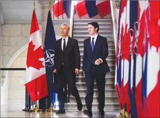  ?? CP PHOTO ?? Prime Minister Justin Trudeau and NATO Secretary General Jens Stoltenber­g arrive to take part in a joint press conference on Parliament Hill in Ottawa on Wednesday.