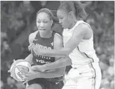  ?? STACY BENGS/ASSOCIATED PRESS ?? Team Delle Donne’s A’ja Wilson, left, controls the against Team Parker’s Rebekkah Brunson. ball