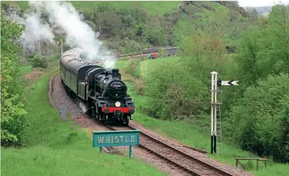  ??  ?? A holiday by the seaside: Making its 'Purbeck Line' debut on short-term loan from the Great Central Railway, BR Standard 2MT 2-6-0 No. 78018 heads past Corfe Castle with a Swanage Railway service train while standing in for Eddystone on May 25. No. 78018 has appeared courtesy of the Loughborou­gh Standard Locomotive­s Group and the Darlington Railway Preservati­on Society, to support the Swanage running fleet following the withdrawal of BR Standard 4MT 2-6-4T No. 80104 from traffic and while Eddystone is being commission­ed. ANDREW PM WRIGHT