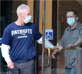  ?? NANCY LANE / HERALD STAFF ?? ‘SUSPECT’: Retired police Sgt. Gerard O’Brien holds the door for retired Patrolman Henry Doherty on Wednesday at federal court in the Seaport. The pair are among nine accused of claiming false overtime.